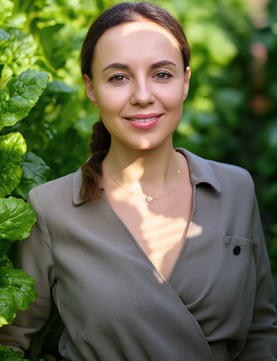 Woman standing among lush green leaves — natural beetroot extract and botanical skincare inspiration by ORY Skincare.