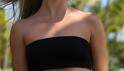Woman in a tropical setting wearing a black top — plant-derived Cetyl Alcohol skincare ingredient for ORY Skincare.