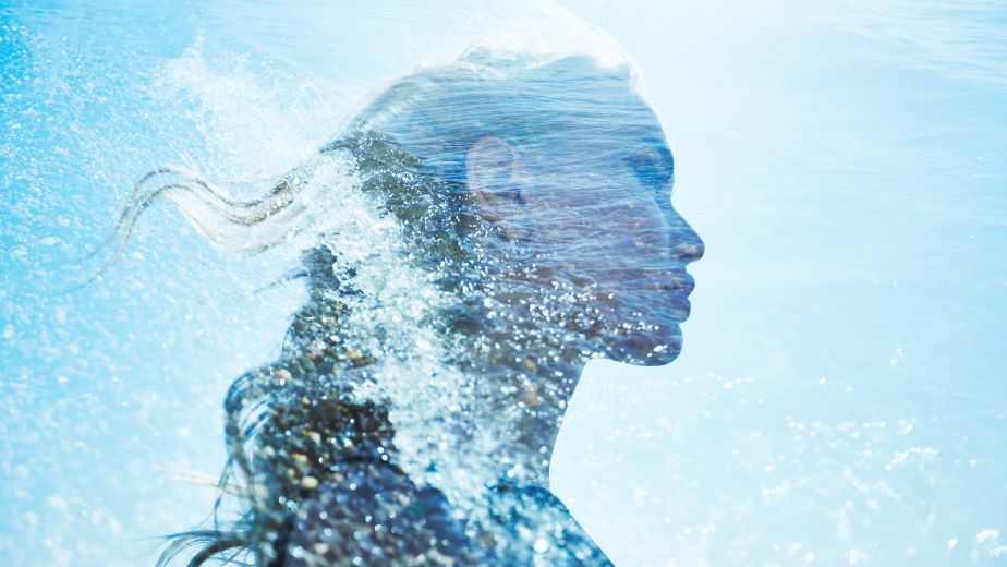 Abstract silhouette of a woman formed by flowing water and light, symbolizing ionized water in skincare and ORY’s science-driven hydration philosophy.