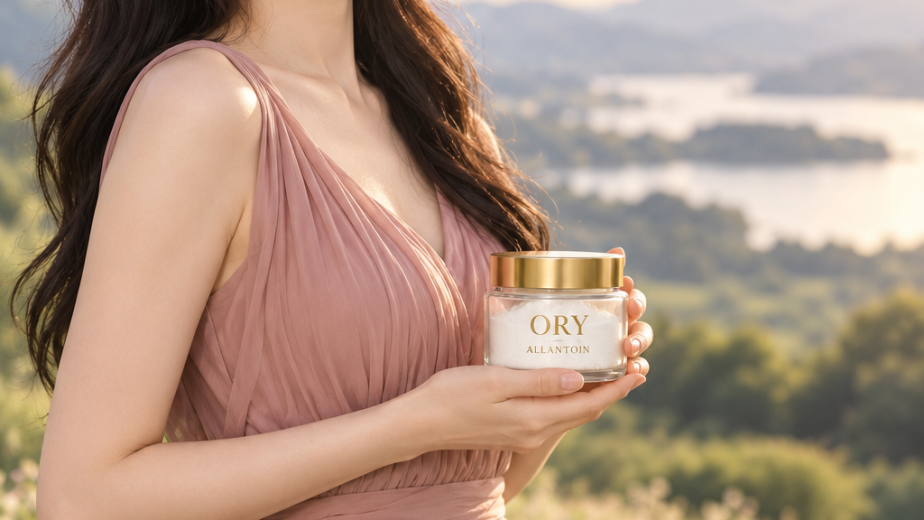 Smiling woman holding an ORY Allantoin jar in a meadow beneath elegant gold lettering.